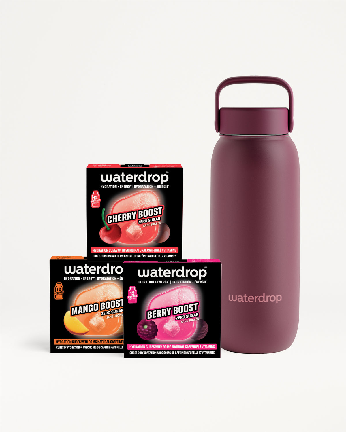 Bottiglia d'acqua isolante magenta con manico accanto a tre piccole scatole nere.