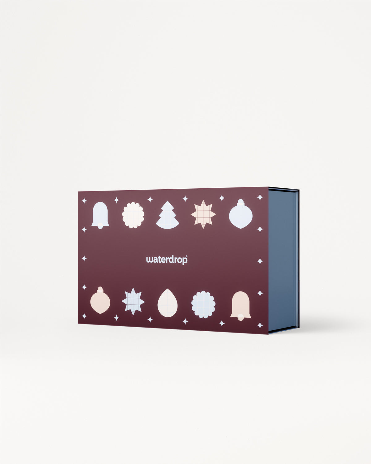 Scatola regalo viola con icone bianche di Natale sul coperchio e interno azzurro.