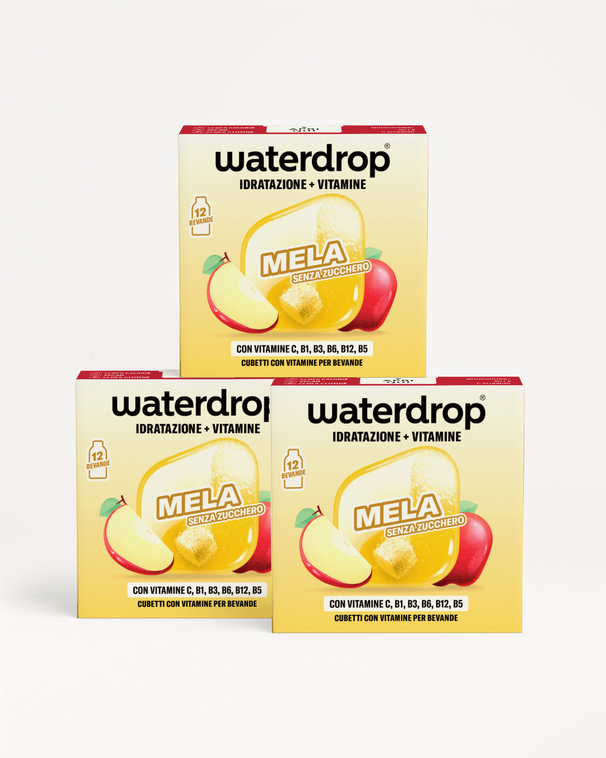Tre scatolegialle con grafica di frutta impilate a piramide su sfondo bianco.
