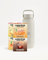 Light gray reusable bottle with a handle beside three small flavor sachets.